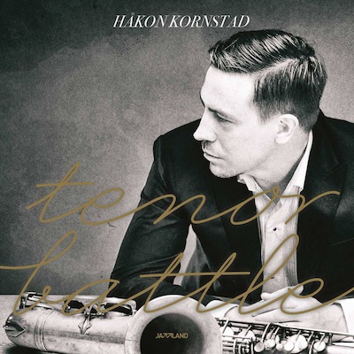 Håkon Kornstad gazes thoughtfully to the side, with a saxophone in front of him.