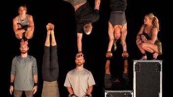 A group of seven acrobats in various poses against a black background, showcasing balancing skills.