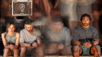 Three seated individuals look at their devices, with blurred figures in motion behind them.