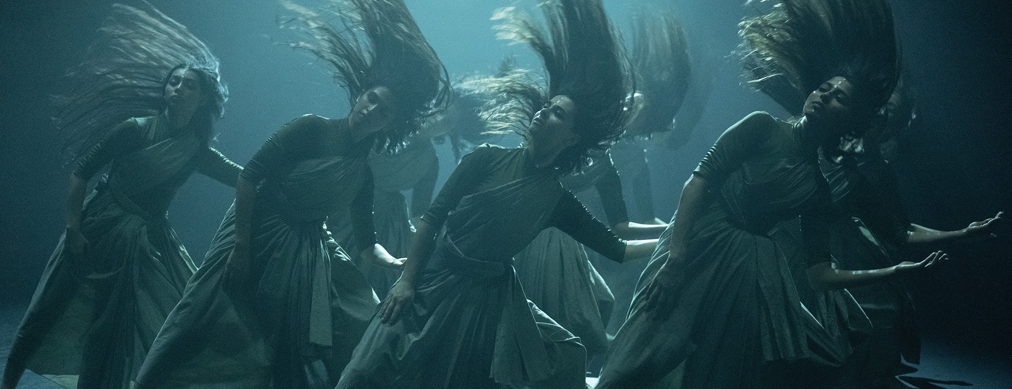 Ethereal underwater digital artwork of four women in flowing dresses, hair drifting