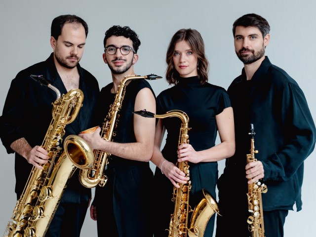 Arcis musicians holding their instruments, dressed in black against a light background.