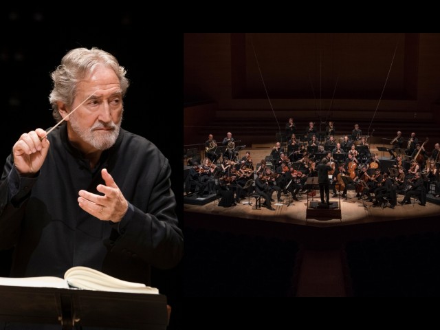 Jordi Saval conductor beside full orchestra on concert stage