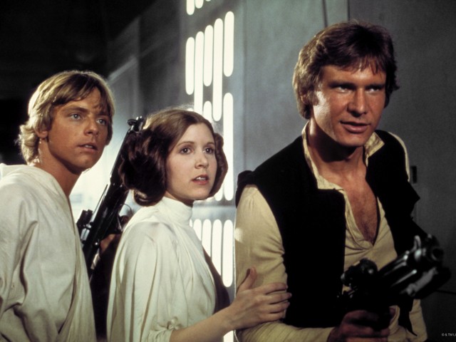 A film still of Luke Skywalker, Princess Lei, and Han Solo