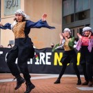Al-Juthoor Dabke in colorful outfits perform outdoors, showcasing their cultural attire.