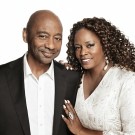 Branford Marsalis in black suit, Dianne Reeves in a white blouse, hand on his chest