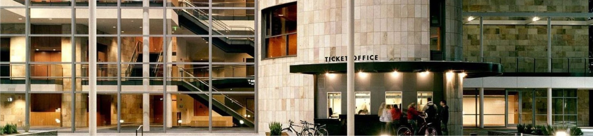 Mondavi Center ticket office at night with lights showing through window