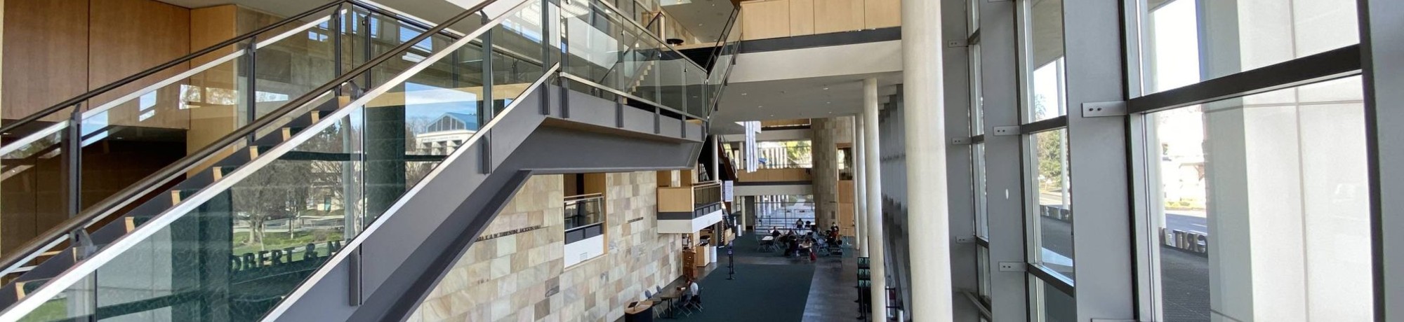 Modern interior of Mondavi Center featuring stairs and large windows.