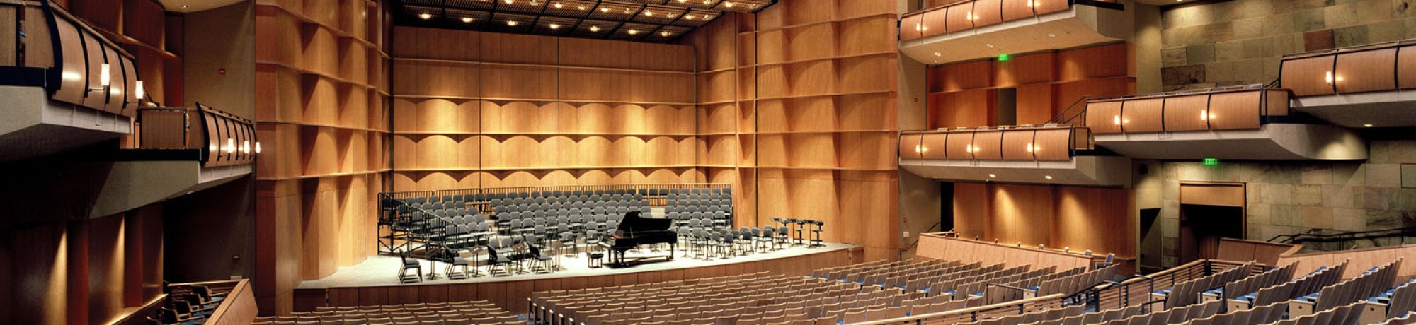 Interior of Mondavi Center with wooden paneling and empty seats.